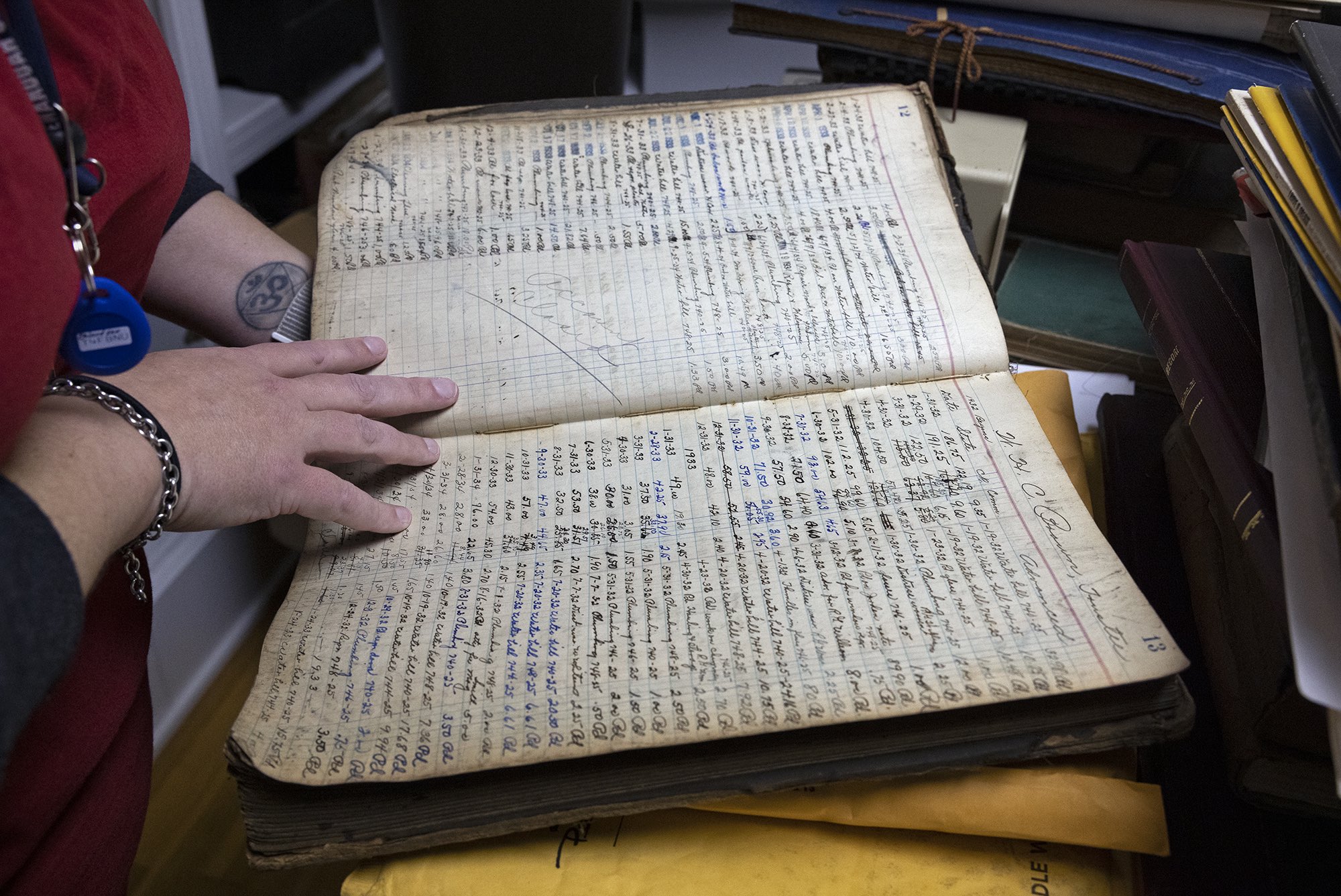 Melissa Erlandson, a records and archives specialist at Jefferson Lab, views an historical ledger at the Newsome House in Newport News, VA.