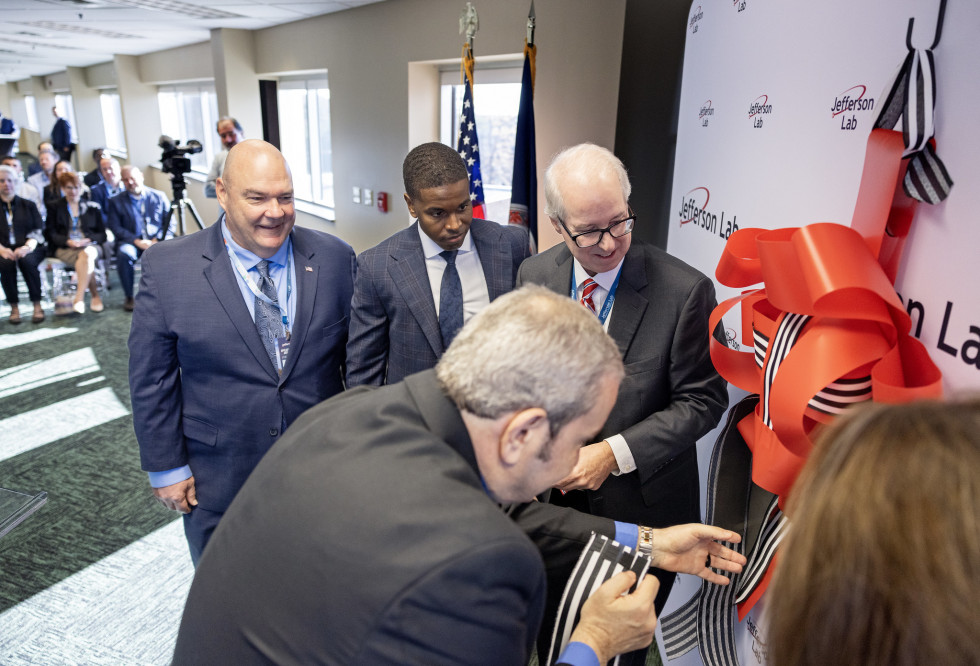 Honored guests tie the ribbon